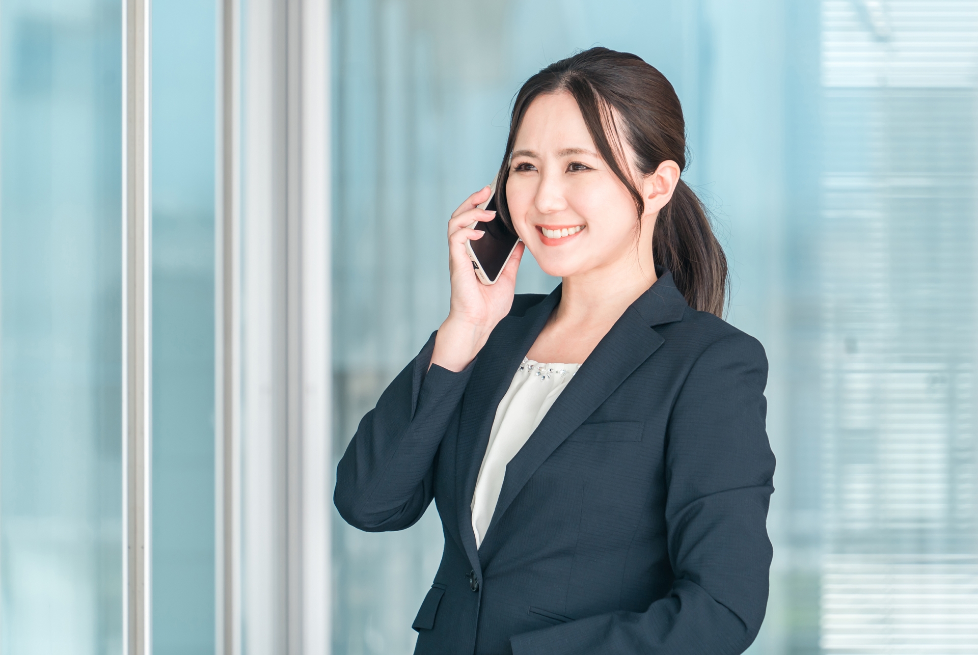 オフィス街で通話するビジネスウーマン