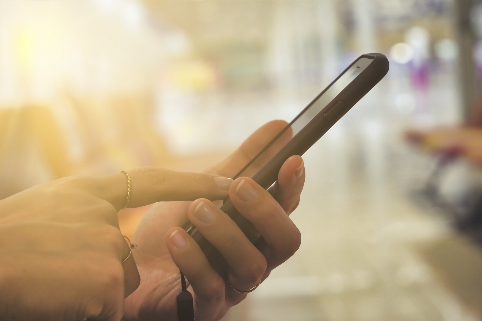 夕日とスマホを操作する人