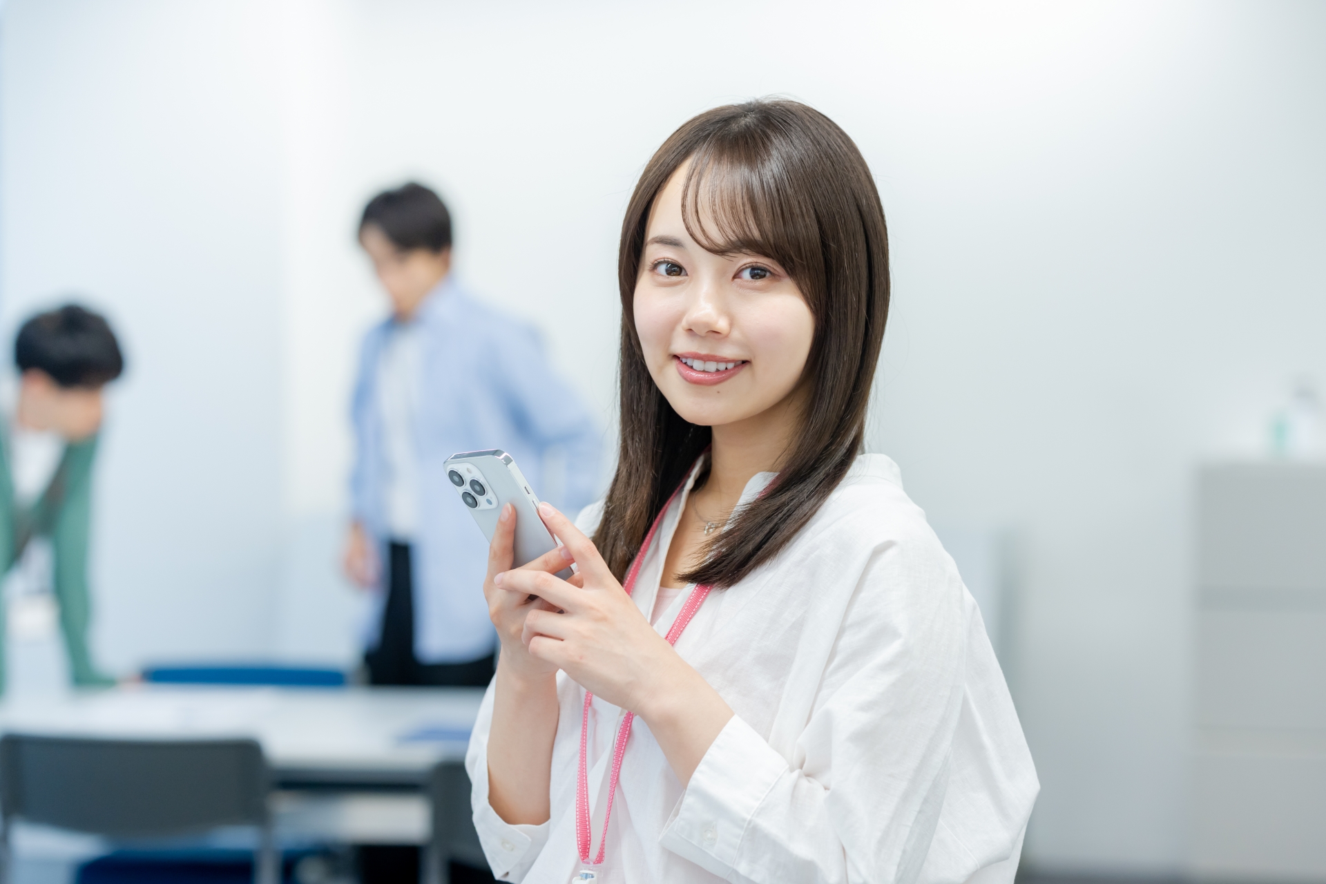 オフィスでスマホを持つビジネスウーマン