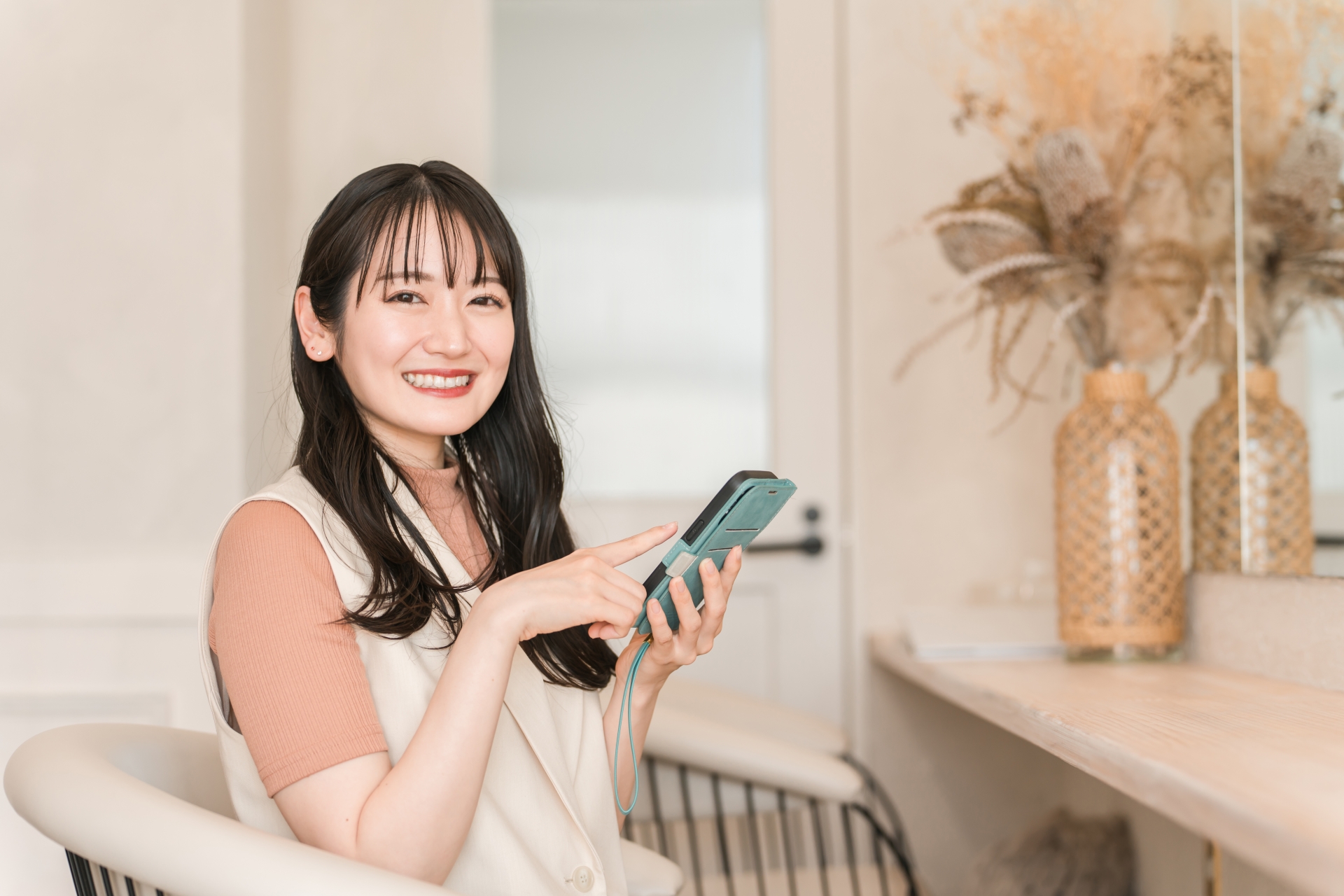 ヘアサロンでスマホを使う女性