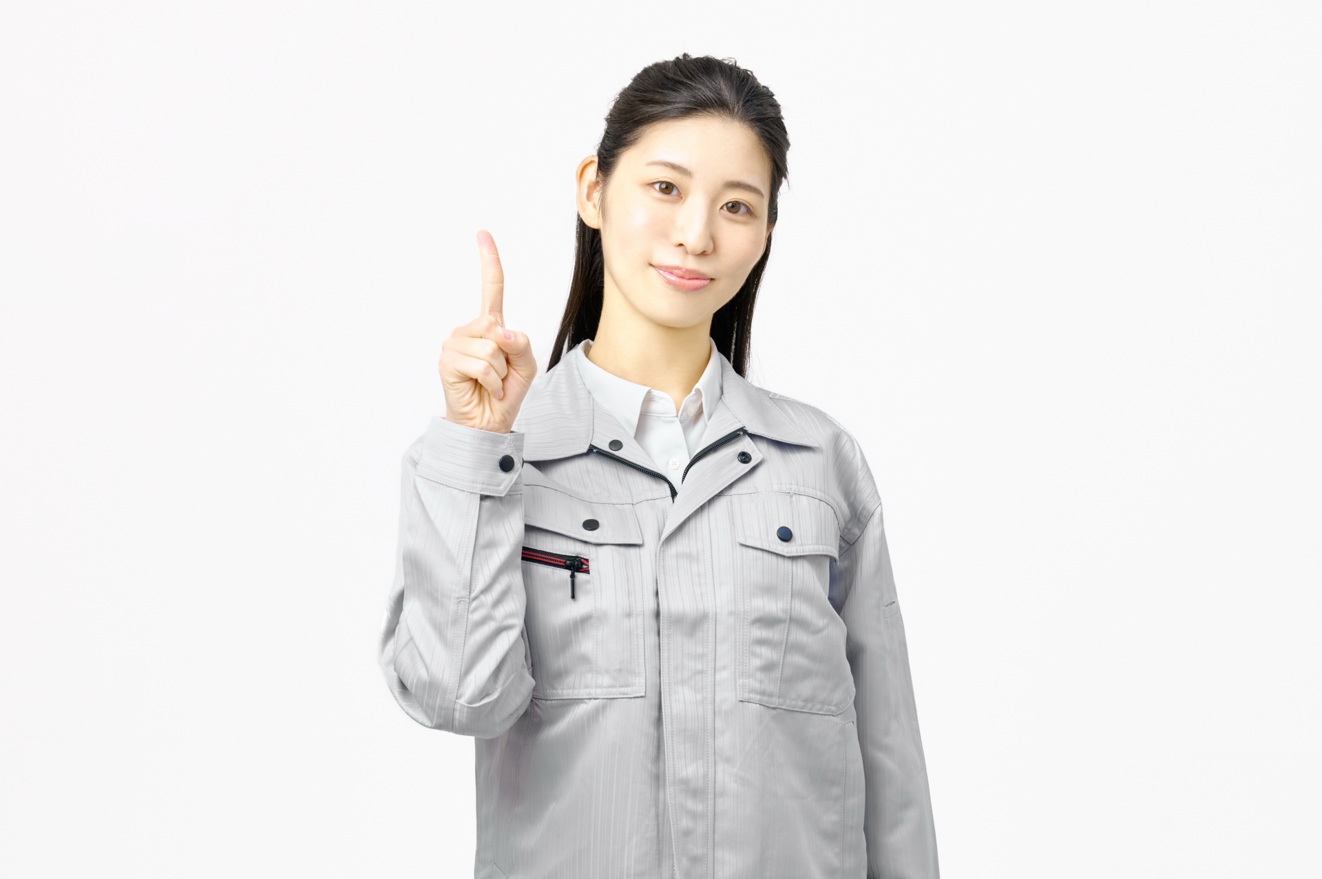 指さしポーズする作業服の女性