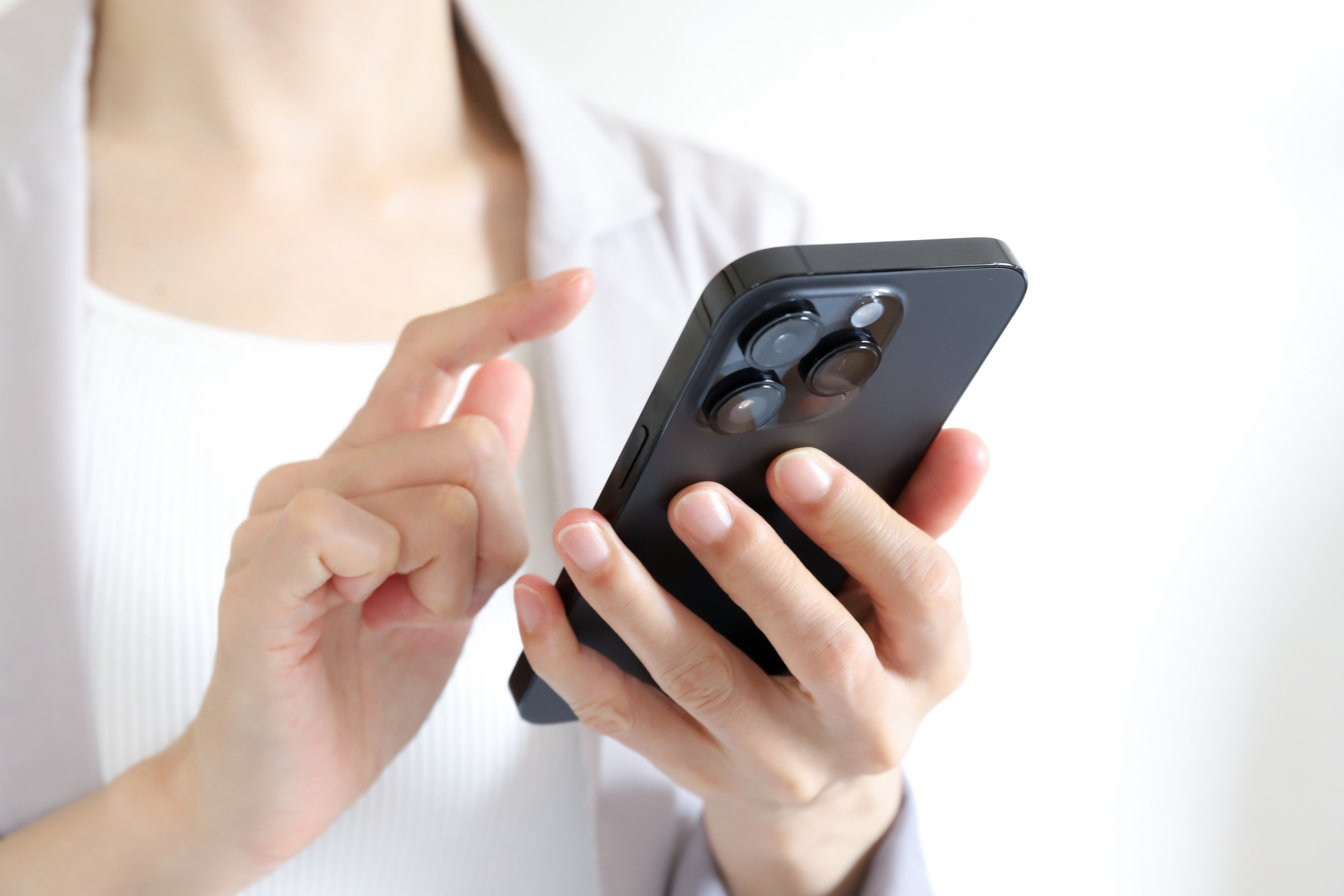 スマートフォンを使う女性の手元