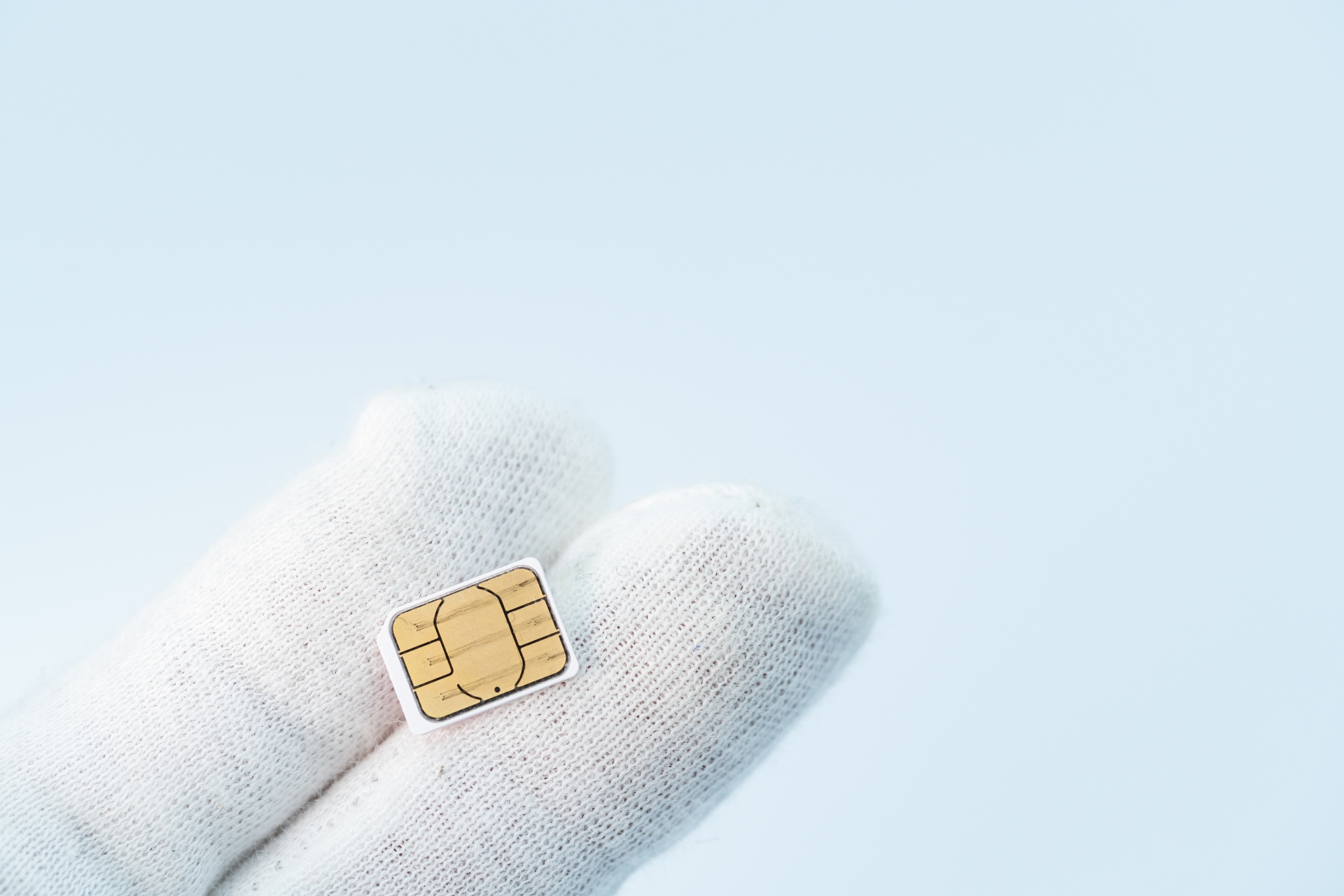 白手袋でSIMカードを持つ人
