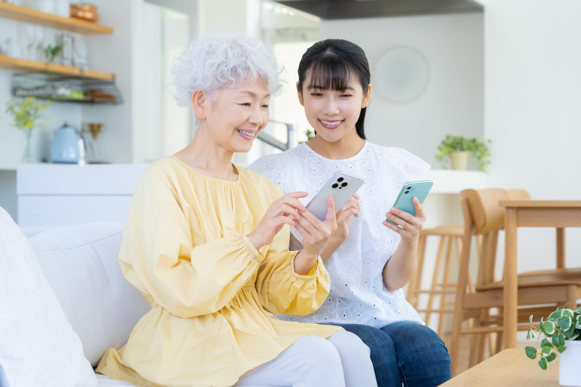 リビングスマホを見てくつろぐ孫と祖母