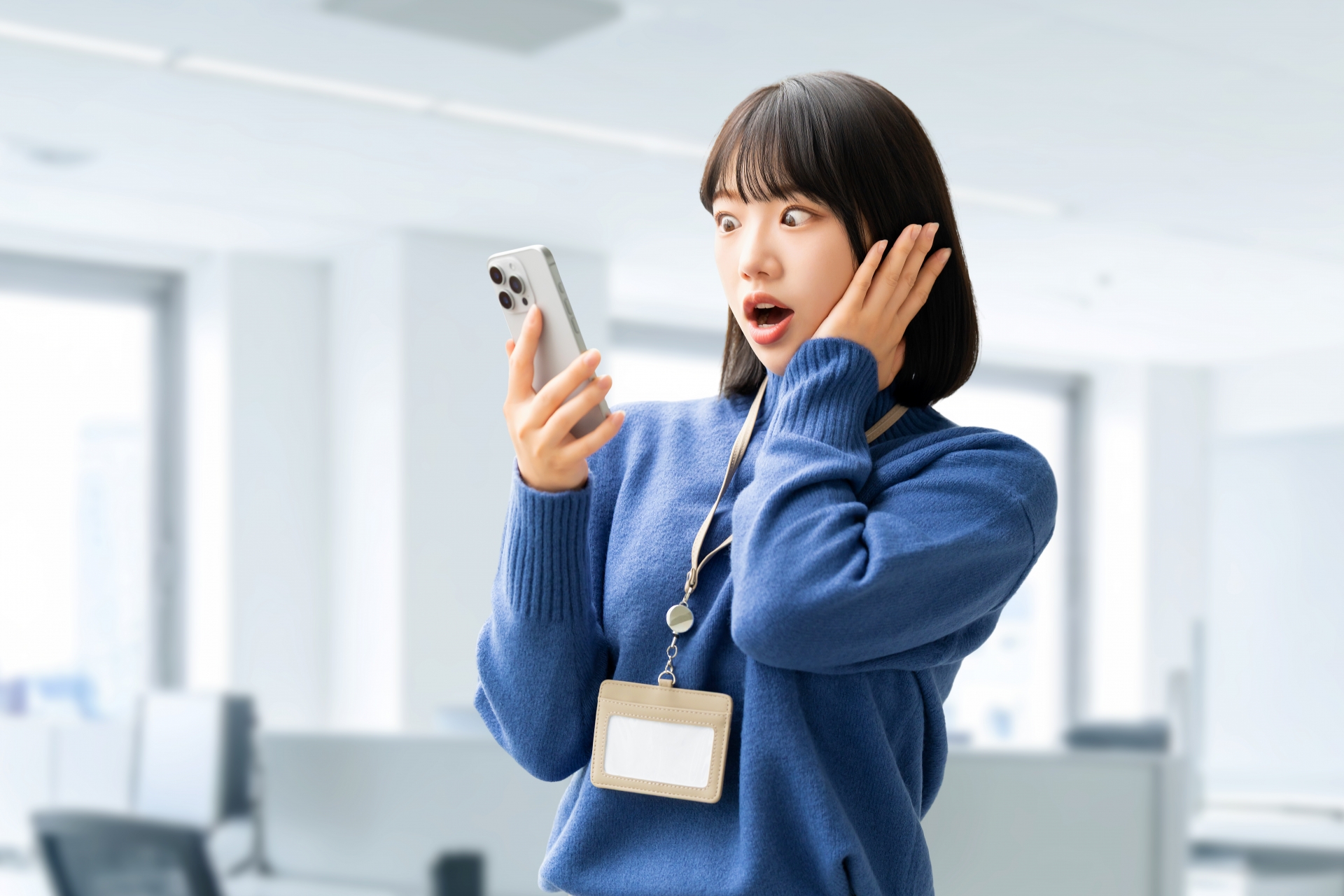 スマホの画面を見て驚くビジネスウーマン