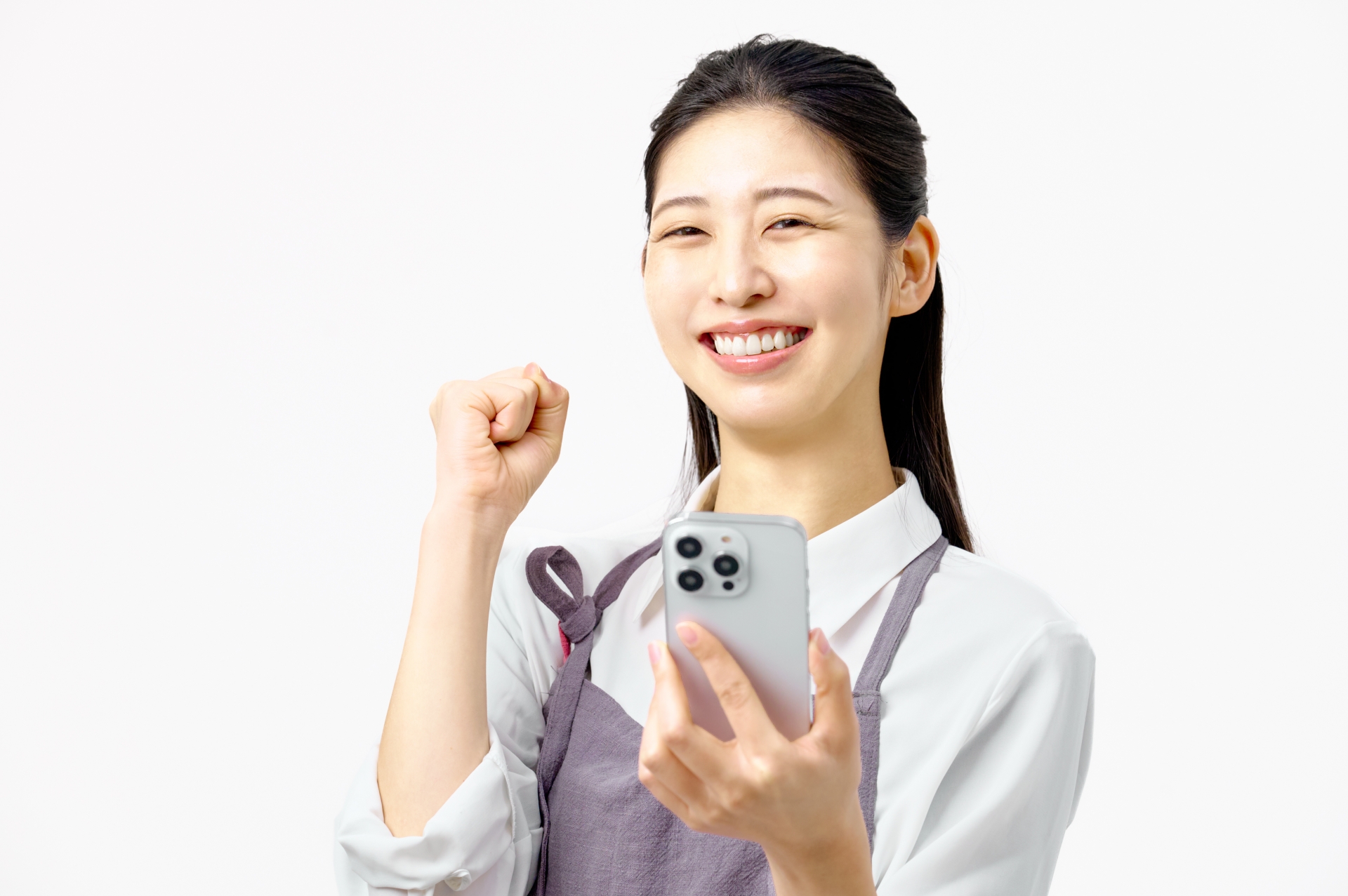 スマホを持ちガッツポーズする主婦　