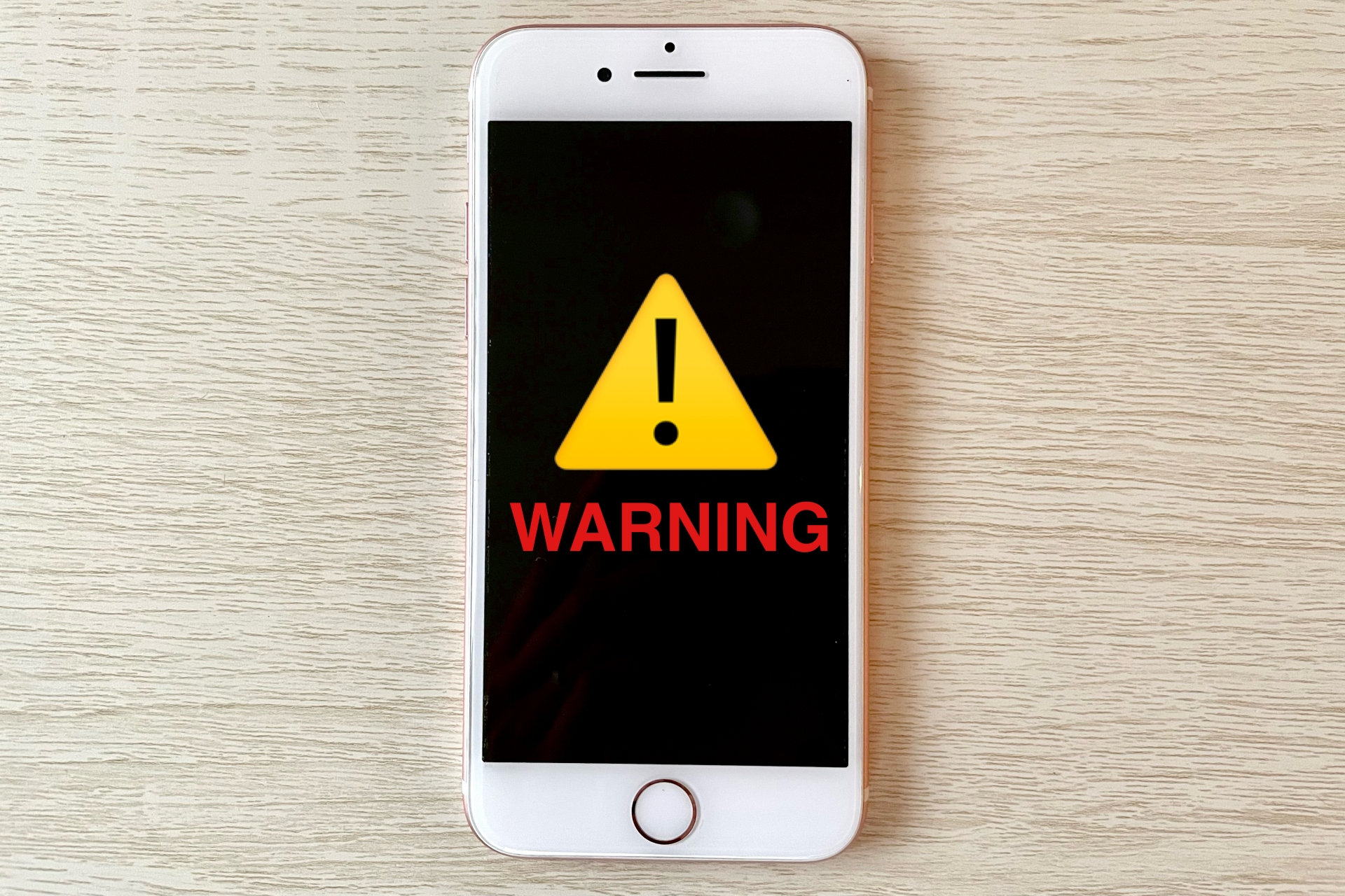 スマホとWARNING 警告マーク